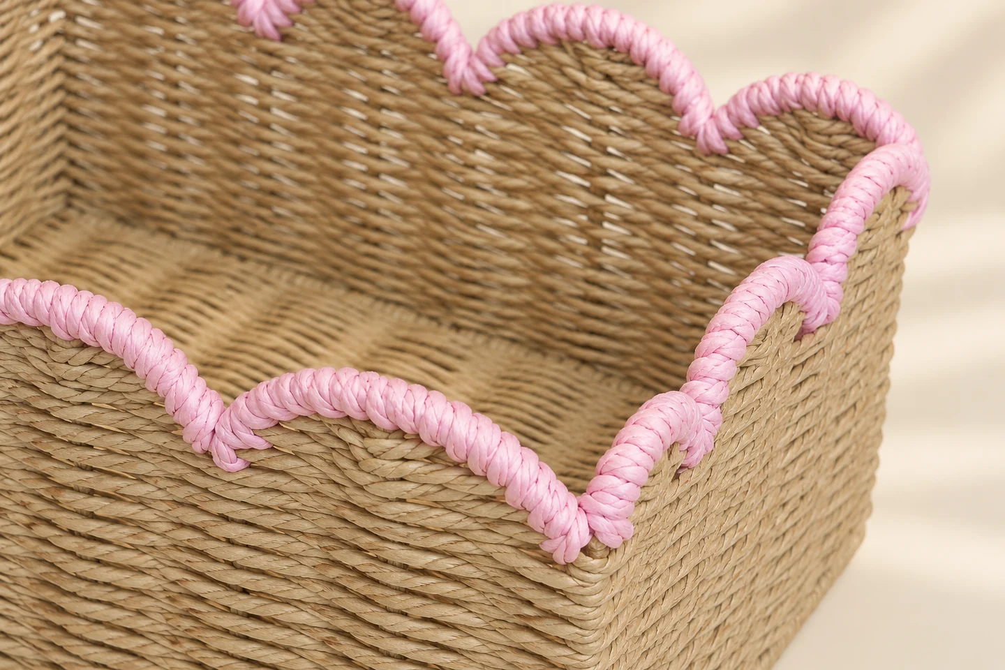 Close view of the pink wrapped scalloped rim and natural-tone paper rope weave
